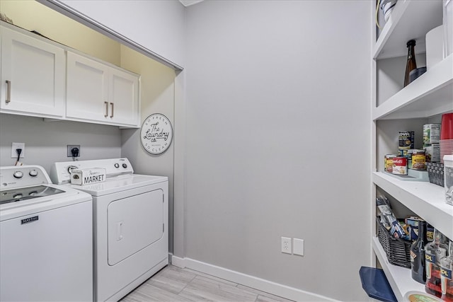 laundry room with light wood-type flooring, cabinets, and washer and dryer