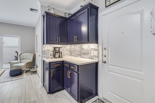 interior space with backsplash, blue cabinetry, and ornamental molding