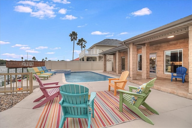 view of pool featuring a water view and a patio