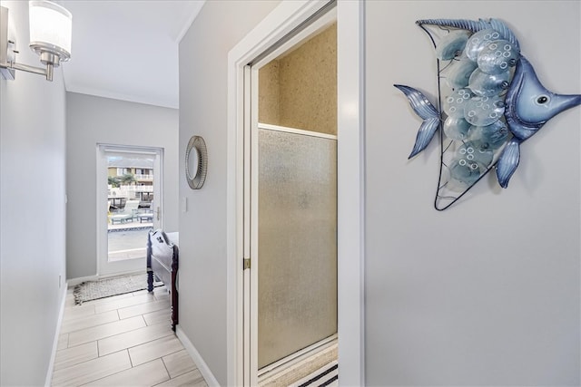 hallway featuring ornamental molding