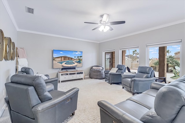 carpeted living room featuring ceiling fan and crown molding