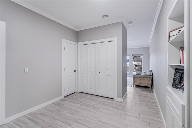 unfurnished bedroom with a closet, light hardwood / wood-style floors, and crown molding