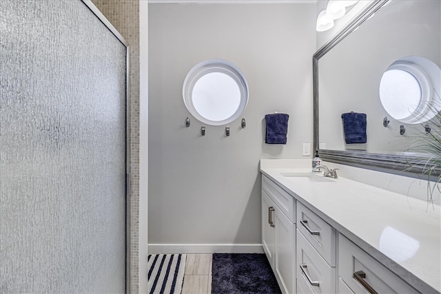 bathroom with tile patterned flooring, plenty of natural light, vanity, and a shower with door