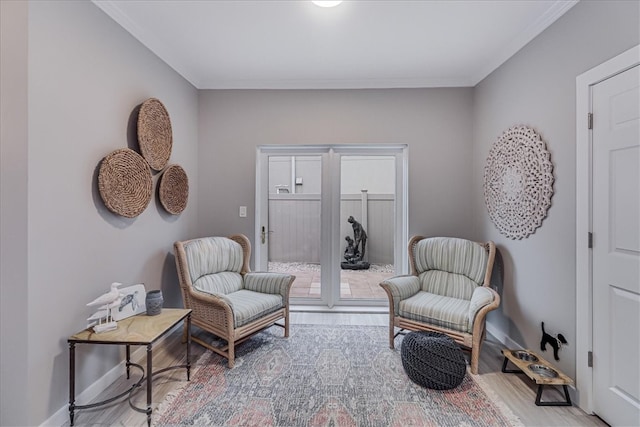 living area featuring light wood-type flooring and ornamental molding