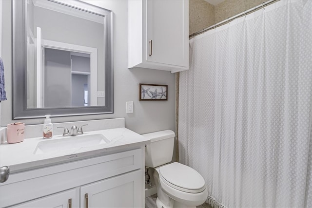 bathroom with toilet, vanity, and walk in shower