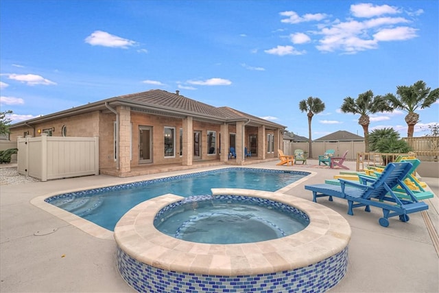 view of pool featuring a patio area and an in ground hot tub