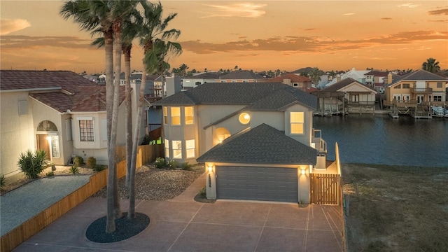 view of front facade with a garage and a water view