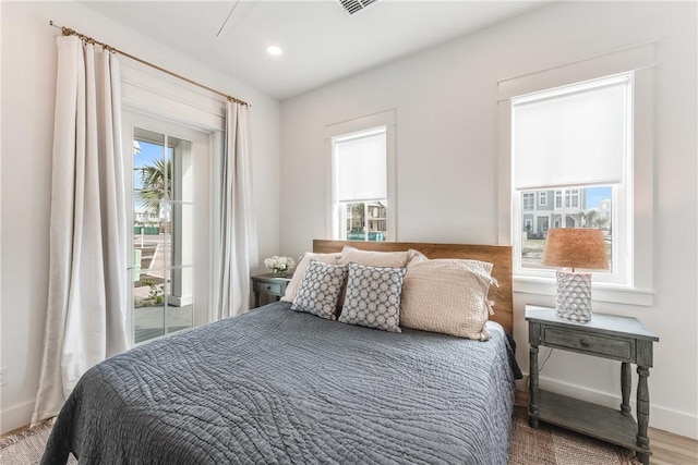 bedroom featuring hardwood / wood-style flooring and access to exterior