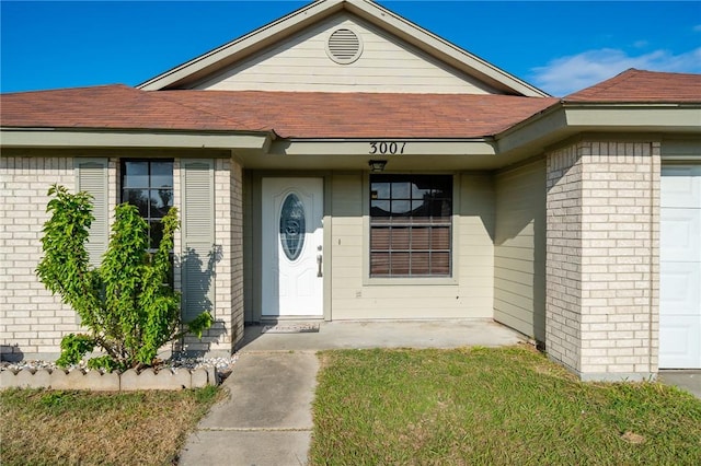 view of exterior entry with a garage