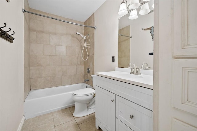 full bathroom featuring vanity, an inviting chandelier, tile patterned floors, tiled shower / bath combo, and toilet