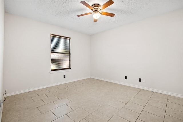 unfurnished room featuring ceiling fan, light tile patterned floors, and a textured ceiling