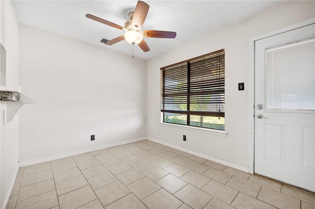 interior space with ceiling fan and light tile patterned flooring