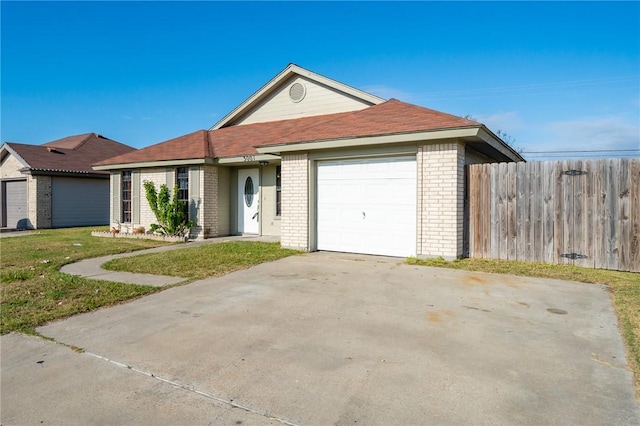 ranch-style house featuring a garage and a front lawn