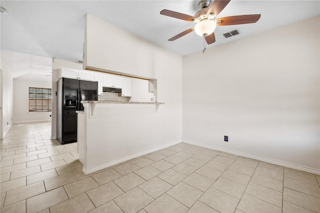 interior space featuring light tile patterned floors and ceiling fan