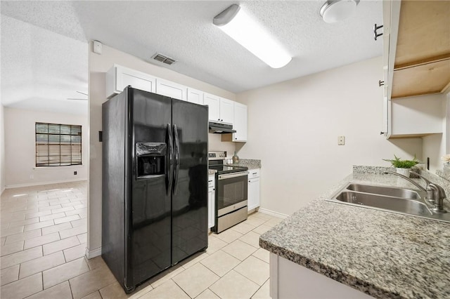 kitchen with black fridge, stainless steel electric stove, sink, white cabinetry, and light tile patterned flooring