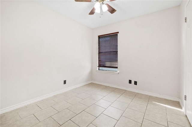 tiled empty room featuring ceiling fan