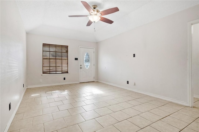 spare room featuring ceiling fan, light tile patterned flooring, a textured ceiling, and vaulted ceiling