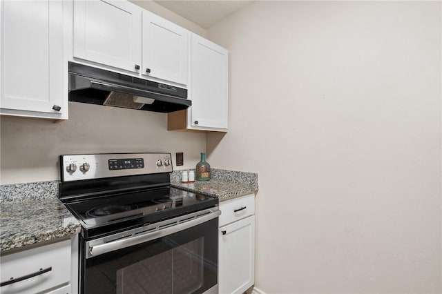 kitchen featuring white cabinets, light stone counters, and stainless steel electric range oven