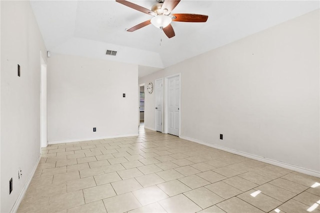 unfurnished room featuring light tile patterned floors, a raised ceiling, and ceiling fan