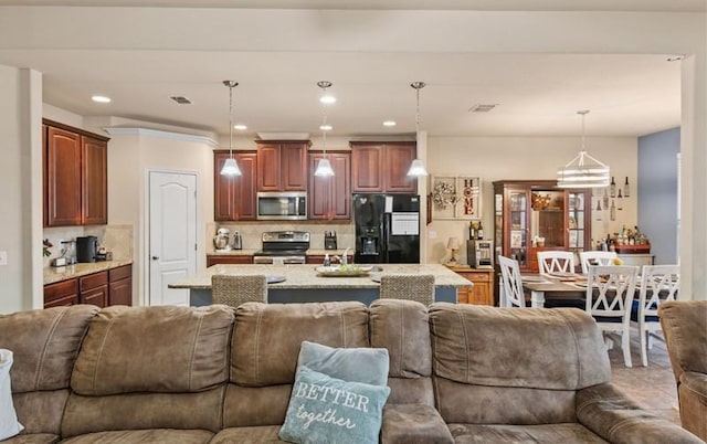 living room featuring recessed lighting and visible vents