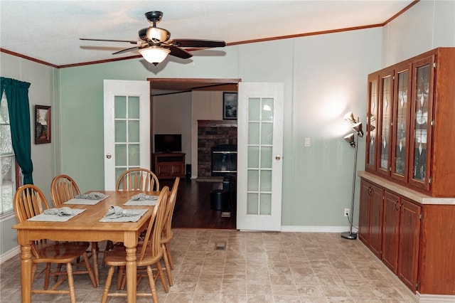 3081 Hackberry Ave, Ingleside, TX 78362 - dining area featuring ornamental molding, ceiling fan, vaulted ceiling, and a glass covered fireplace