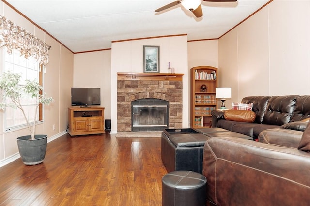 3081 Hackberry Ave, Ingleside, TX 78362 - living room featuring crown molding, dark wood-style floors, a ceiling fan, and a fireplace