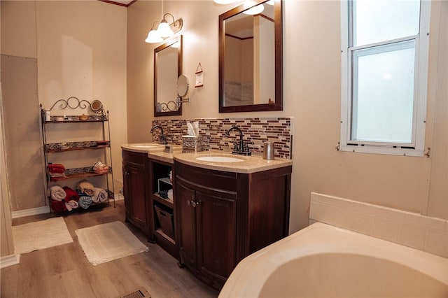 3081 Hackberry Ave, Ingleside, TX 78362 - full bath featuring tasteful backsplash, wood finished floors, two vanities, and a garden tub