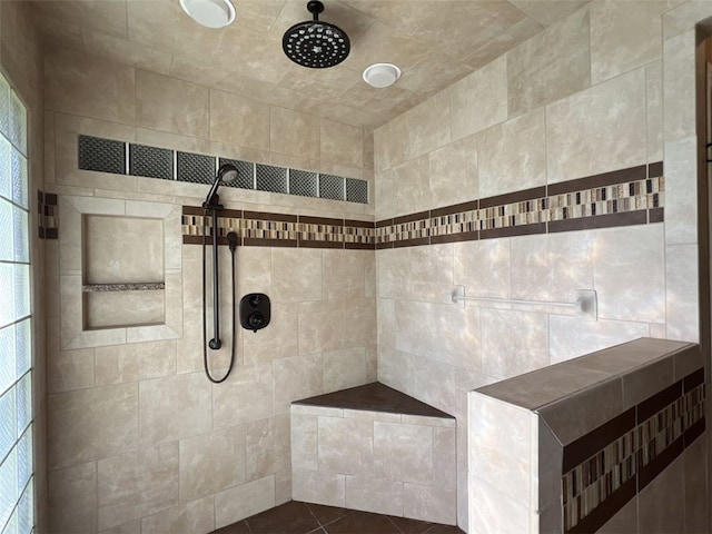 bathroom featuring tile walls, tile patterned flooring, and tiled shower