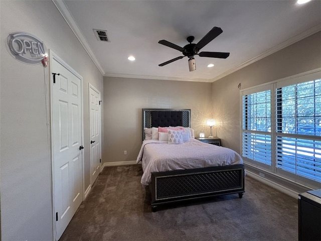 bedroom with ornamental molding, dark carpet, and ceiling fan