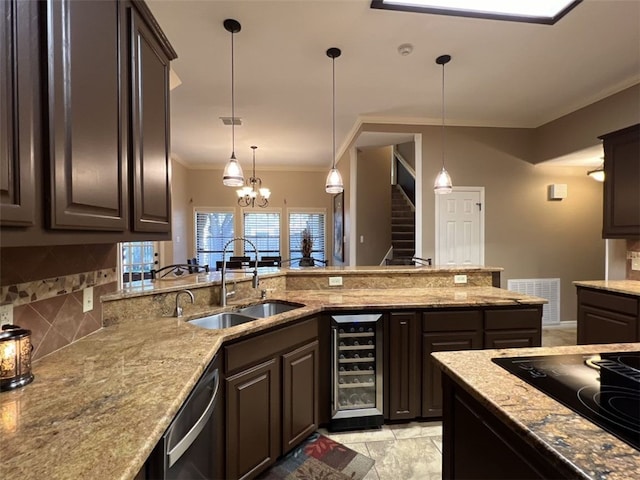 kitchen featuring dark brown cabinetry, sink, beverage cooler, crown molding, and pendant lighting