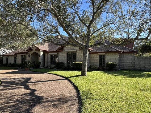 ranch-style home with a front lawn