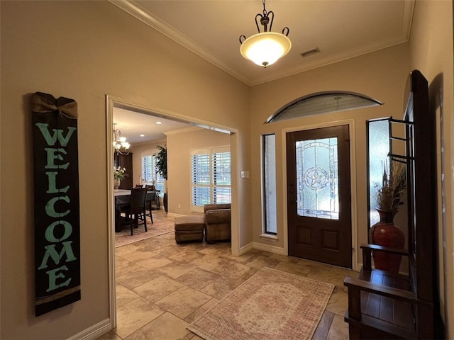 entryway featuring a notable chandelier and ornamental molding