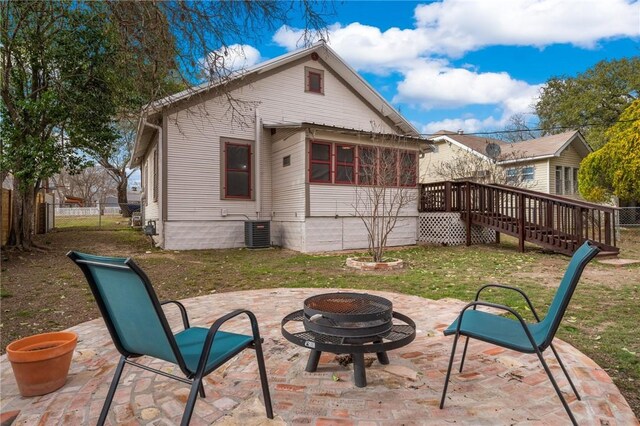 rear view of house featuring a patio area, a lawn, an outdoor fire pit, and fence