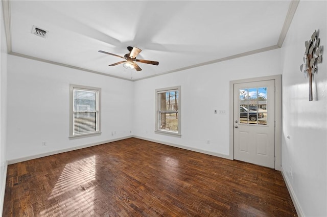 unfurnished room featuring ornamental molding, visible vents, dark wood-style flooring, and ceiling fan