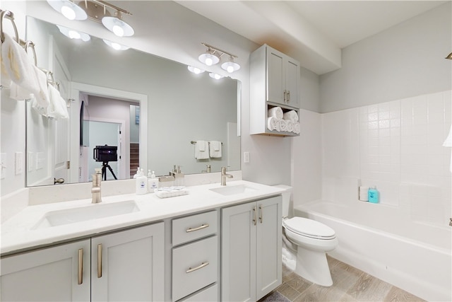 full bathroom with wood-type flooring, vanity, toilet, and shower / tub combination