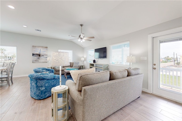 living room with light wood-type flooring, ceiling fan, and vaulted ceiling