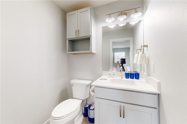 bathroom featuring toilet and vanity