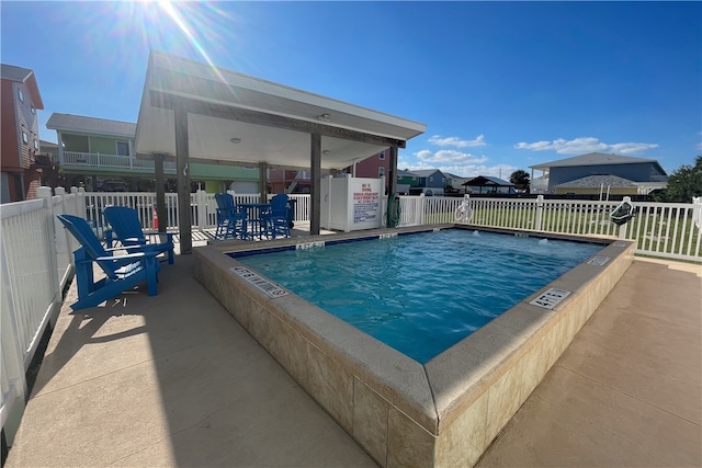 view of swimming pool with a hot tub and a patio area