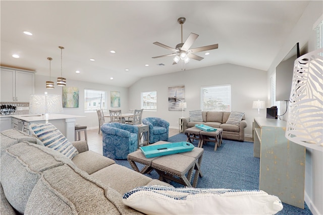 carpeted living room featuring vaulted ceiling, ceiling fan, and plenty of natural light