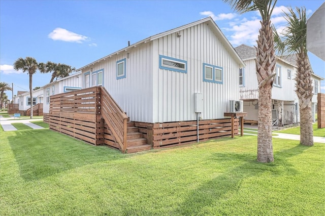 back of house with a lawn and ac unit