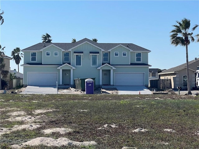 view of front property featuring a garage and a front lawn