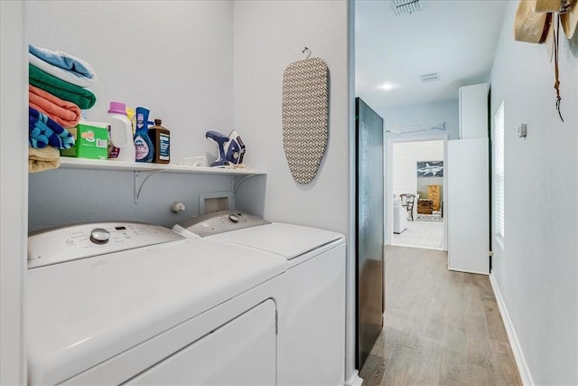 67 Augusta Cir, Aransas Pass, TX 78336 - washroom featuring washer and clothes dryer and light wood-style floors