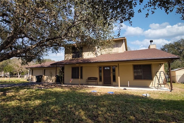 view of front of property featuring a patio, a chimney, an attached garage, fence, and a front lawn