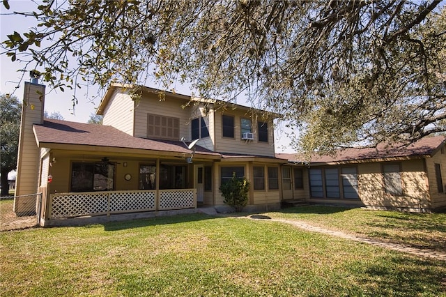 back of property featuring cooling unit, a yard, a chimney, and fence