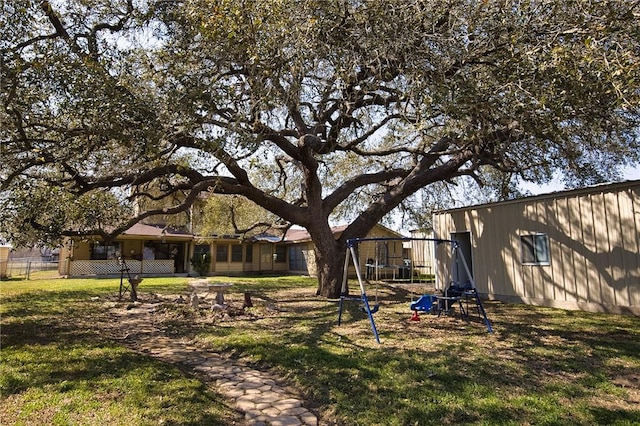 view of yard featuring fence and a playground