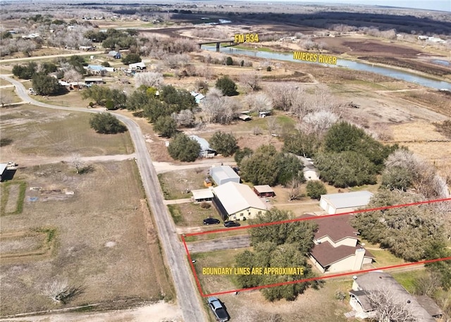 birds eye view of property featuring a water view and a rural view