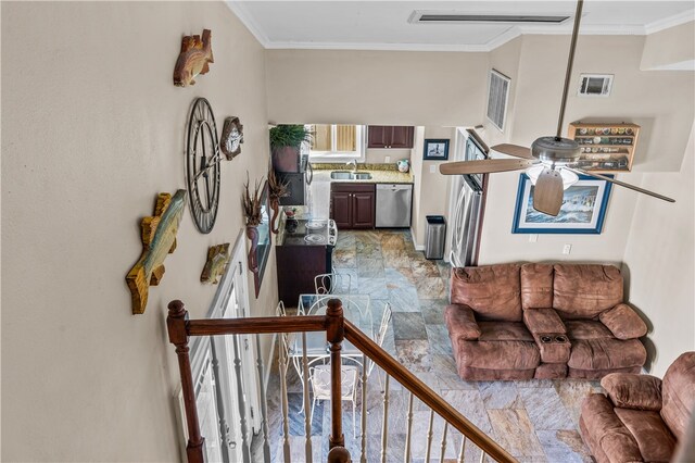 living room featuring sink, crown molding, and ceiling fan