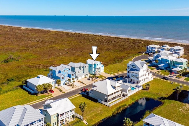 bird's eye view featuring a water view and a view of the beach