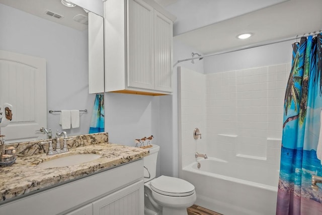 full bathroom featuring toilet, shower / tub combo, and vanity