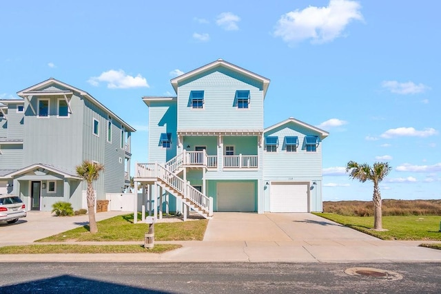 view of front facade with a garage, a porch, and a front lawn